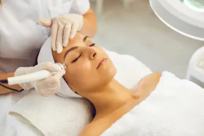Woman experiencing the exclusive Mermaid Facial treatment at Kansas City's Aesthetics For Women luxury spa. Professional KC aesthetician applying specialized marine-infused skincare therapy, featuring premium Missouri-sourced ingredients. Transform your c