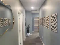 Stylish interior hallway at Kansas City's exclusive Aesthetics For Women clinic, featuring contemporary design elements and sophisticated decor. Experience the calming atmosphere of KC's premier women's med spa, where attention to detail reflects the qual