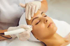 Woman experiencing the exclusive Mermaid Facial treatment at Kansas City's Aesthetics For Women luxury spa. Professional KC aesthetician applying specialized marine-infused skincare therapy, featuring premium Missouri-sourced ingredients. Transform your c