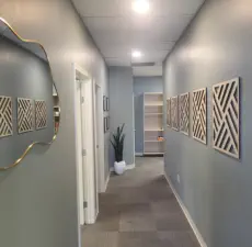 Stylish interior hallway at Kansas City's exclusive Aesthetics For Women clinic, featuring contemporary design elements and sophisticated decor. Experience the calming atmosphere of KC's premier women's med spa, where attention to detail reflects the qual
